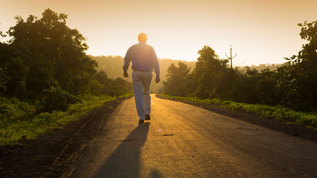 Man walking into sunrise
